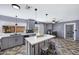 Updated kitchen with gray cabinets, island, stainless appliances, and sliding door access to the backyard at 2921 N 103Rd Ave, Avondale, AZ 85392