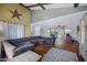 Spacious living room featuring a large sectional sofa, wooden floors, and brick wall accents at 2921 N 103Rd Ave, Avondale, AZ 85392