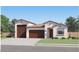 Charming single-story home featuring a three-car garage and a well-manicured front yard at 3160 E Craftsman Ln, San Tan Valley, AZ 85140