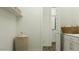 Bright laundry room boasts modern cabinetry, countertop space, and a convenient woven hamper at 3160 E Craftsman Ln, San Tan Valley, AZ 85140