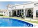 Beautiful backyard featuring a sparkling pool, artificial turf, and a modern home with black framed windows and doors at 3330 S Horizon Pl, Chandler, AZ 85248