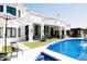Stunning backyard with a pool, manicured artificial turf, and a white modern home with expansive windows at 3330 S Horizon Pl, Chandler, AZ 85248