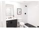 Bathroom with black fixtures, white subway tile, patterned floors, and a black framed mirror above a white vanity at 3330 S Horizon Pl, Chandler, AZ 85248