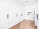 Bright laundry room with white cabinets, modern washer/dryer, and light hardwood floors at 3330 S Horizon Pl, Chandler, AZ 85248