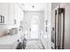 Clean laundry room with washer, dryer, ample storage, stylish herringbone floors, and lots of counter space at 3330 S Horizon Pl, Chandler, AZ 85248