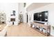 Open-concept living room featuring a fireplace, high ceilings, wood floors, and lots of natural light at 3330 S Horizon Pl, Chandler, AZ 85248