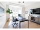 Home office with modern decor, including a large desk, stylish ceiling fan, and natural light from bay windows at 3330 S Horizon Pl, Chandler, AZ 85248