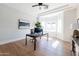 Bright home office with hardwood floors, modern desk, ceiling fan, and large windows at 3330 S Horizon Pl, Chandler, AZ 85248