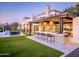 A stunning backyard featuring an outdoor bar with pendant lighting and ample seating at 3330 S Horizon Pl, Chandler, AZ 85248