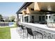 Chic outdoor bar with seating overlooking the pool and backyard, ideal for enjoying refreshments in style at 3330 S Horizon Pl, Chandler, AZ 85248