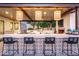 Stylish outdoor bar area with unique tile detailing, pendant lighting, and ample seating, ideal for entertaining guests at 3330 S Horizon Pl, Chandler, AZ 85248