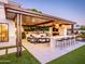 Elegant outdoor kitchen featuring a built-in grill, bar seating, and comfortable lounge area for ultimate outdoor enjoyment at 3330 S Horizon Pl, Chandler, AZ 85248