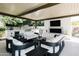 Spacious outdoor living area with ample seating, a built-in grill, and a cozy fireplace, ideal for entertaining and relaxation at 3330 S Horizon Pl, Chandler, AZ 85248