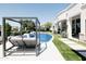 Inviting backyard features a sparkling pool with water features and a cozy lounge area, perfect for outdoor enjoyment at 3330 S Horizon Pl, Chandler, AZ 85248