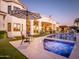 Elegant backyard with a sparkling pool, lush landscaping, and a cozy seating area, perfect for outdoor gatherings at 3330 S Horizon Pl, Chandler, AZ 85248