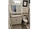 Compact bathroom with modern fixtures, a granite countertop, a stylish mirror, and ample storage space at 3615 E Hearn Rd, Phoenix, AZ 85032