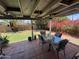 Charming covered patio featuring a glass table with comfortable seating surrounded by lush greenery at 3615 E Hearn Rd, Phoenix, AZ 85032
