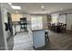 Bright, modern kitchen with stainless steel appliances, granite counters, a kitchen island, and an adjacent dining area at 3615 E Hearn Rd, Phoenix, AZ 85032