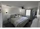 Serene bedroom with soft lighting, a ceiling fan, plush bedding, and light-colored walls for a relaxing atmosphere at 3615 E Hearn Rd, Phoenix, AZ 85032