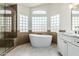 Bright bathroom showing a tub, frameless glass shower, glass block windows and modern vanity at 3851 E San Pedro Ave, Gilbert, AZ 85234