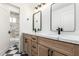 Bathroom featuring double vanities with marble countertops, designer mirrors, and tiled flooring at 3851 E San Pedro Ave, Gilbert, AZ 85234