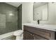 Bathroom featuring a tiled shower with a glass door, sleek vanity, and modern fixtures at 3851 E San Pedro Ave, Gilbert, AZ 85234