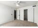 Bedroom with doorway to bathroom, closet with shelving, carpet, and ceiling fan for comfort at 3851 E San Pedro Ave, Gilbert, AZ 85234
