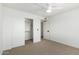 Clean bedroom includes carpet, a ceiling fan, closet, and a white door leading to another room at 3851 E San Pedro Ave, Gilbert, AZ 85234