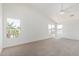 Spacious, carpeted bedroom filled with natural light from multiple windows and ceiling fan at 3851 E San Pedro Ave, Gilbert, AZ 85234
