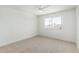 Light-filled bedroom with large window, plush carpeting, and minimalist design for comfortable living at 3851 E San Pedro Ave, Gilbert, AZ 85234