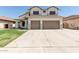 Two-story home features a two-car garage, green lawn, and desert landscaping at 3851 E San Pedro Ave, Gilbert, AZ 85234