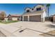 Two-story home features a two-car garage, green lawn, desert landscaping, and a palm tree at 3851 E San Pedro Ave, Gilbert, AZ 85234