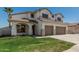 Two-story home features a two-car garage, green lawn, and desert landscaping at 3851 E San Pedro Ave, Gilbert, AZ 85234