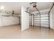 Spacious three-car garage with epoxy floors and overhead storage racks at 3851 E San Pedro Ave, Gilbert, AZ 85234