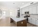 Bright open kitchen featuring white cabinetry, an island with quartz countertop and hardwood floors at 3851 E San Pedro Ave, Gilbert, AZ 85234
