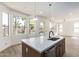 Bright, modern kitchen features a quartz island, stainless steel appliances, and view to backyard at 3851 E San Pedro Ave, Gilbert, AZ 85234
