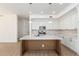 A bright kitchen featuring white cabinetry, an island with quartz countertop and hardwood floors at 3851 E San Pedro Ave, Gilbert, AZ 85234