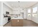 Modern kitchen with white cabinetry, stainless steel appliances, and an island with quartz countertop at 3851 E San Pedro Ave, Gilbert, AZ 85234