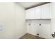 Bright laundry room with white cabinets and flooring and essential hookups for convenience at 3851 E San Pedro Ave, Gilbert, AZ 85234