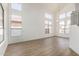Bright, open living room featuring hardwood floors, high ceilings, and numerous large windows at 3851 E San Pedro Ave, Gilbert, AZ 85234