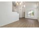 A spacious living room showcasing hardwood floors and natural light from the large windows at 3851 E San Pedro Ave, Gilbert, AZ 85234