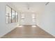 A well-lit living room highlighting hardwood floors, white walls, and a ceiling fan at 3851 E San Pedro Ave, Gilbert, AZ 85234