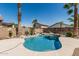 Sparkling blue pool surrounded by lush landscaping and mature palm trees at 3851 E San Pedro Ave, Gilbert, AZ 85234