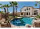 Stunning backyard oasis with pool, lush landscaping, and mature palm trees at 3851 E San Pedro Ave, Gilbert, AZ 85234