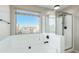 A luxurious bathroom features a soaking tub and glass shower at 3910 W Goldmine Mountain Dr, San Tan Valley, AZ 85144