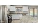 Bright kitchen featuring granite countertops, stainless steel appliances and backyard pool view at 3910 W Goldmine Mountain Dr, San Tan Valley, AZ 85144