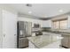 Modern kitchen with granite countertops, stainless steel appliances, and white cabinetry at 3910 W Goldmine Mountain Dr, San Tan Valley, AZ 85144
