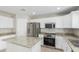 Well-lit kitchen featuring granite countertops and stainless steel appliances at 3910 W Goldmine Mountain Dr, San Tan Valley, AZ 85144