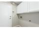 Bright laundry room features white cabinets and a neutral color scheme, offering a clean and functional space at 3910 W Goldmine Mountain Dr, San Tan Valley, AZ 85144