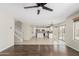 Spacious open-concept living room with tile flooring, staircase, and view of the kitchen at 3910 W Goldmine Mountain Dr, San Tan Valley, AZ 85144